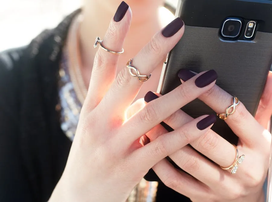 Deep plum matte almond nails with stacked silver rings
