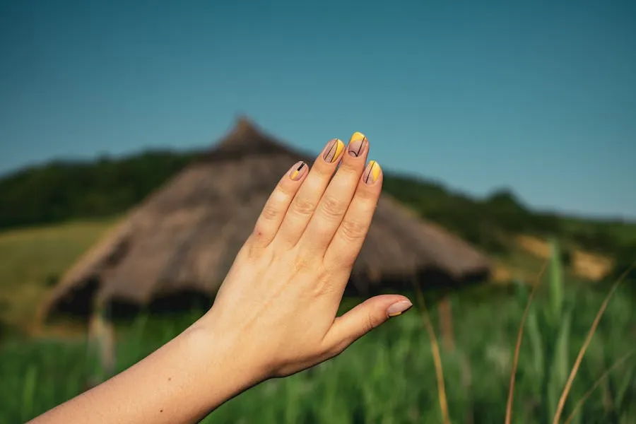 Warm amber nails with fine black line art detail